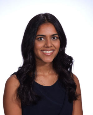 Portrait of Dr. Rupanshi Garg, general dentist, smiling against a light background