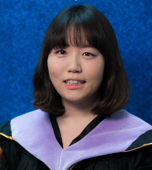 Portrait of Dr. Yoona Lee in academic dress against a blue background
