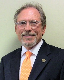 Portrait of Dr. David G. Sabott wearing a suit and tie